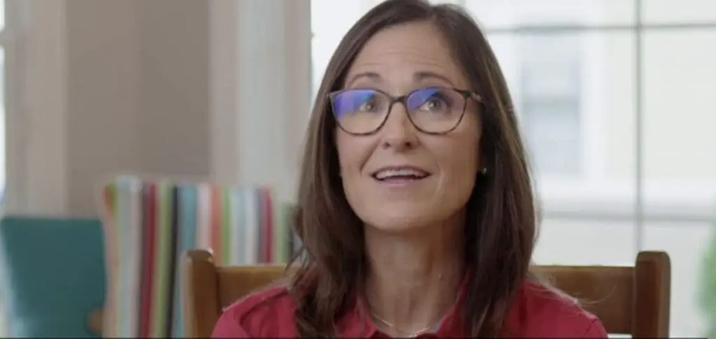 woman with glasses smiling